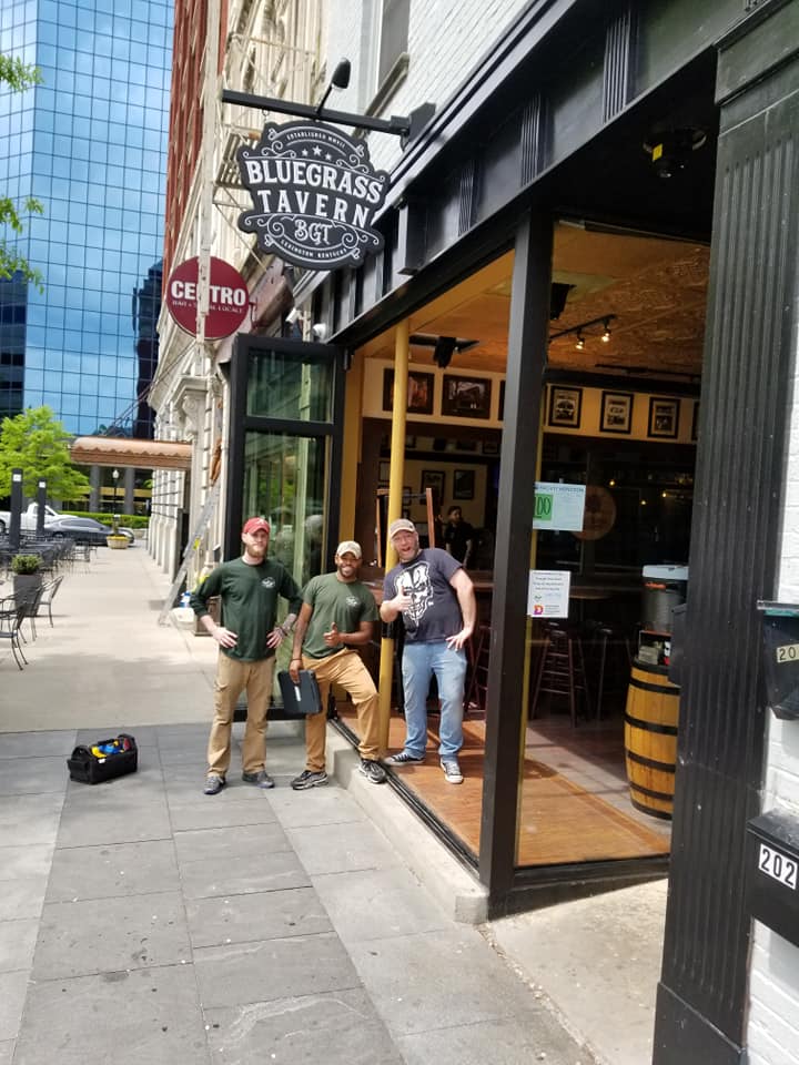 Three Little Guys standing outside Bluegrass Tavern in Lexington