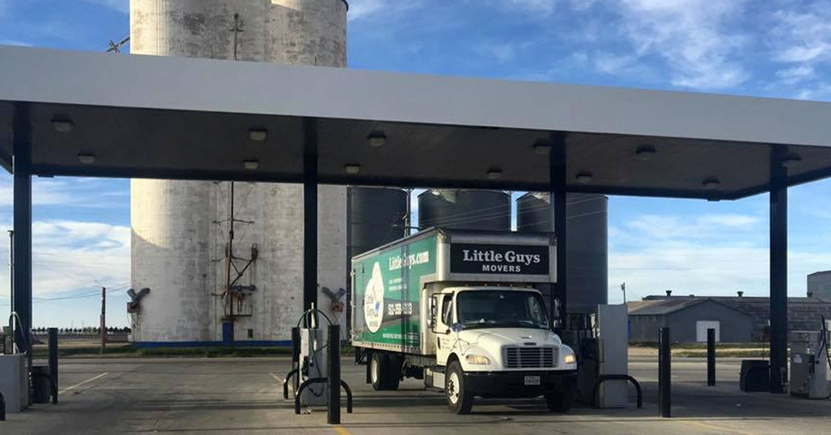 Little Guys Round Rock movers truck in front of silo