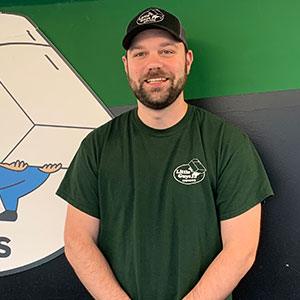 Charlie, the Little Guys Movers' Branch Manager in Raleigh smiles for the camera