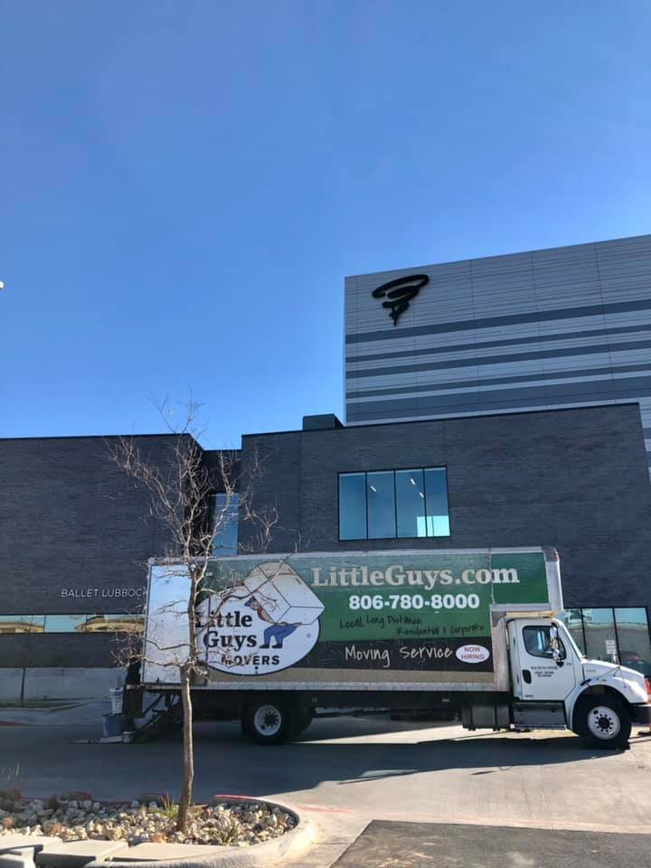 Little Guys Movers truck in front of Buddy Holly Hall