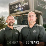 Little Guys Movers founders Chris and Marcus in front of a moving truck