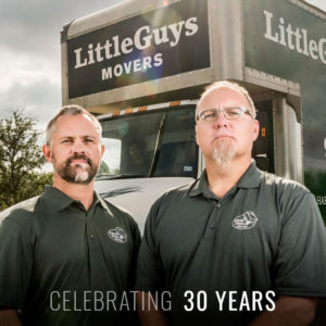 Little Guys Movers founders Chris and Marcus in front of a moving truck