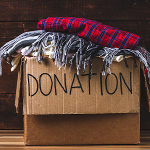 A box of clothing with "DONATION" written on it in permanent marker.