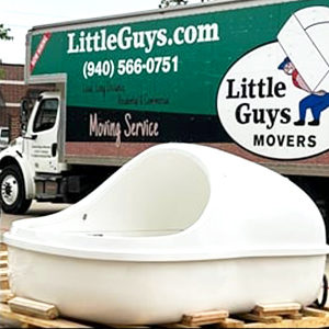 A float pod is photographed in front of a Little Guys truck.