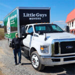 Little Guys Movers moving truck and mover in Nashville.
