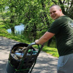 A Little Guys mover wheels a full can of litter out of the Murfreesboro Greenway.