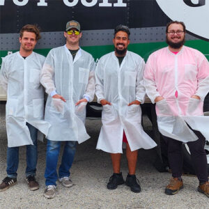 Little Guys Movers crew in San Marcos wear lab coats while packing up lab equipment