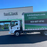 Little Guys Movers moving truck in front of a food bank in Raleigh, NC
