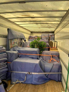 Little Guys Movers in Bryan/College Station pack the moving truck neatly using blankets and straps