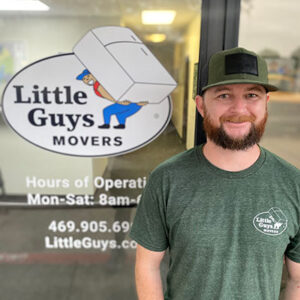 The manager of Little Guys Movers in McKinney smiles at the camera
