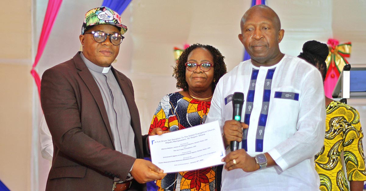 Members of the Global Evangelical Church in the Oti Region of Ghana present a certificate of gratitude